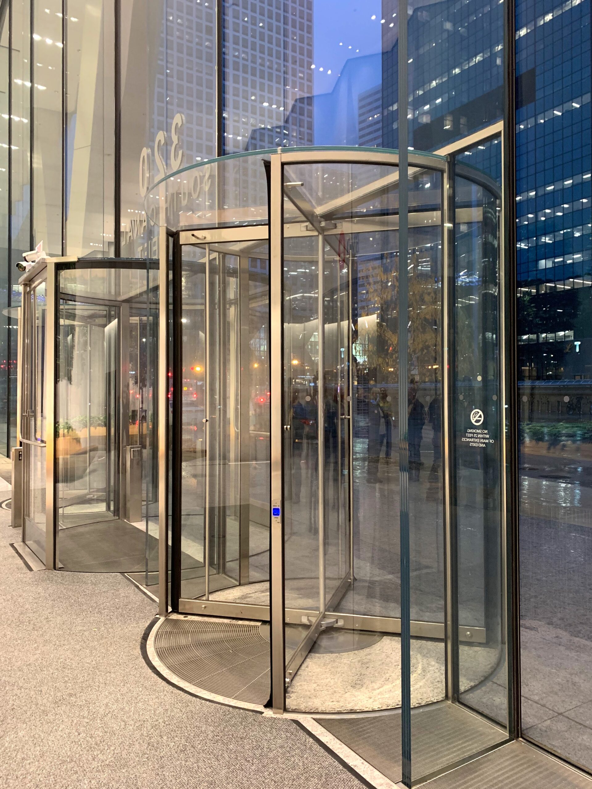 A photo of an architectural building product. An interior entrance to a large building, showing glass revolving doors.