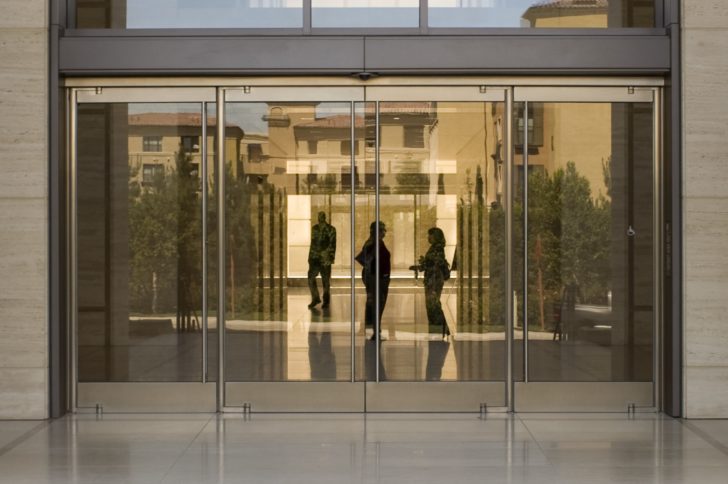 A photo of an architectural building product. An exterior entrance to a large building, showing glass doors.