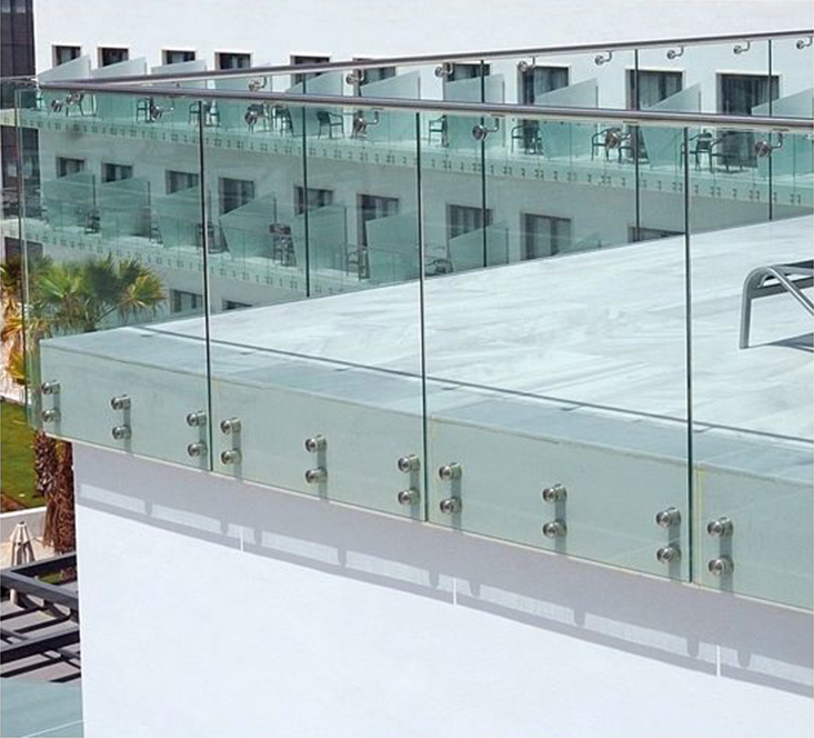 A photo of an architectural building product. An exterior of a building, showing a glass railing around a deck.